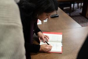 Ana Lucia Araujo signing books. Photo by Daniel Vieira