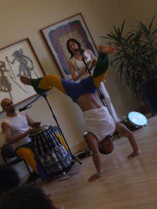 A capoeirista performs a handstand